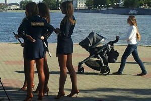 Three police officers next to a lake in a short skirt