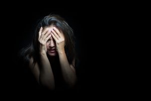 Woman covering his face with her hands and crying