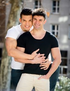 two happy gay men hold each other