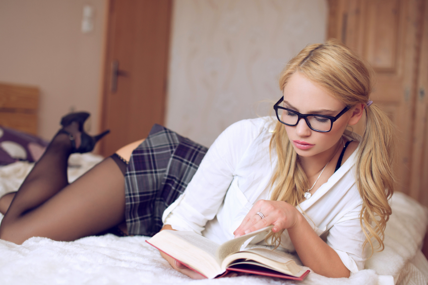 Sexy clever woman reading book in college