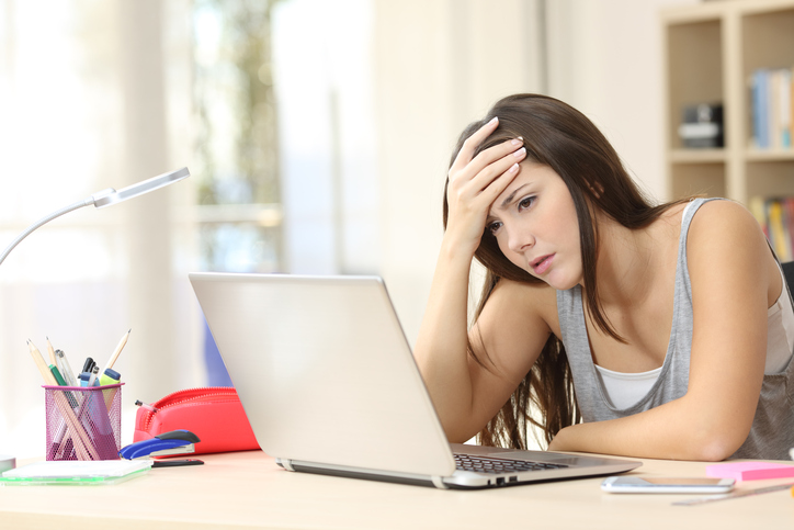 Stressed woman looking at a laptop