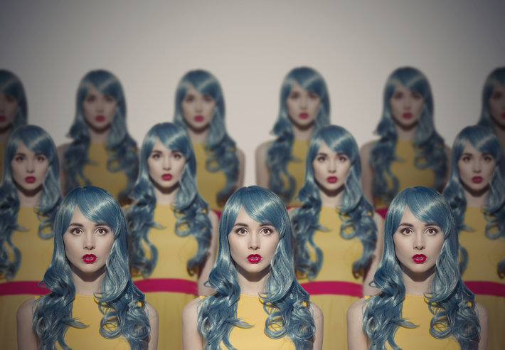 Many Glamour Beauty Woman Clones. Identical Crowd Concept. On Gray Background.