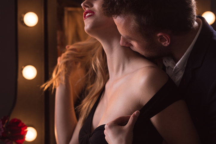 Horizontal picture of mature man kissing beautiful woman's neck