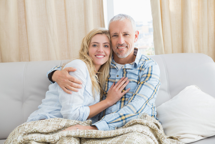 Older man and younger woman on couch