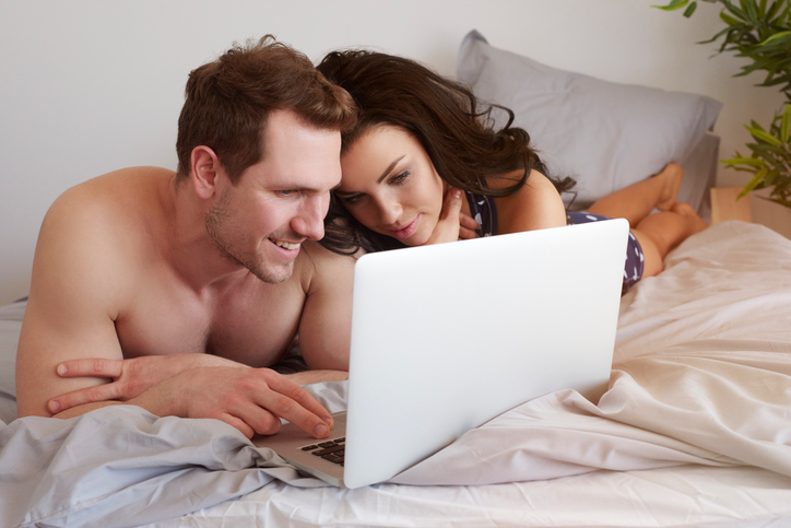 couple on bed with laptop