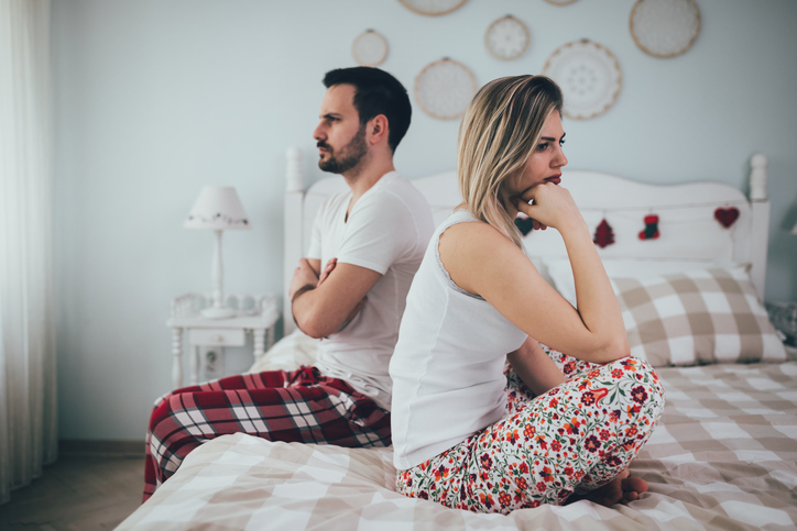 unhappy couple back to back in bed