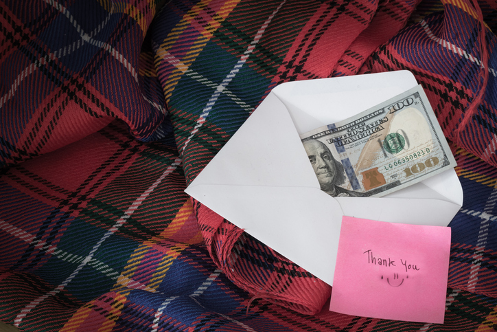 Money in envelope on bed!