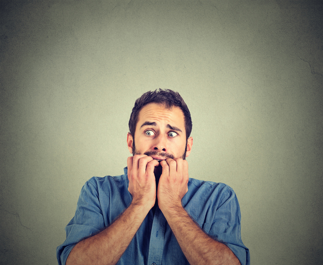 Portrait anxious young man biting his nails fingers freaking out