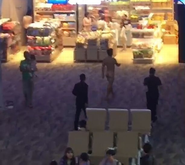 naked man walks around airport