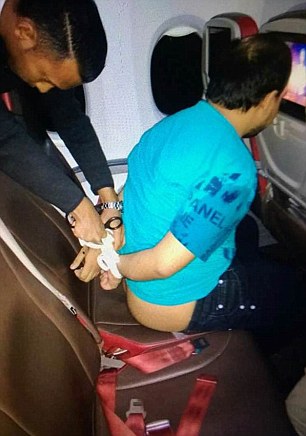 man on plane being arrested