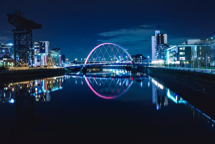 Night view of the Clyde Arc or Squinty Bridge from the East and river Clyde, Glasgow, Scotland