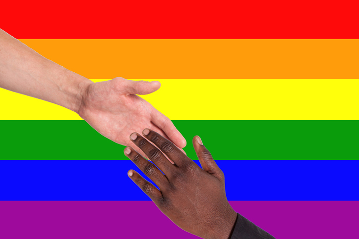 LGBTQ flag with black and white hand