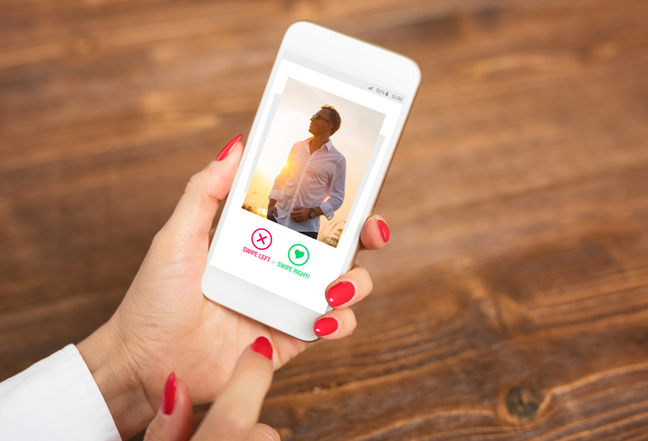 Unrecognizable woman using dating app and swiping user photos