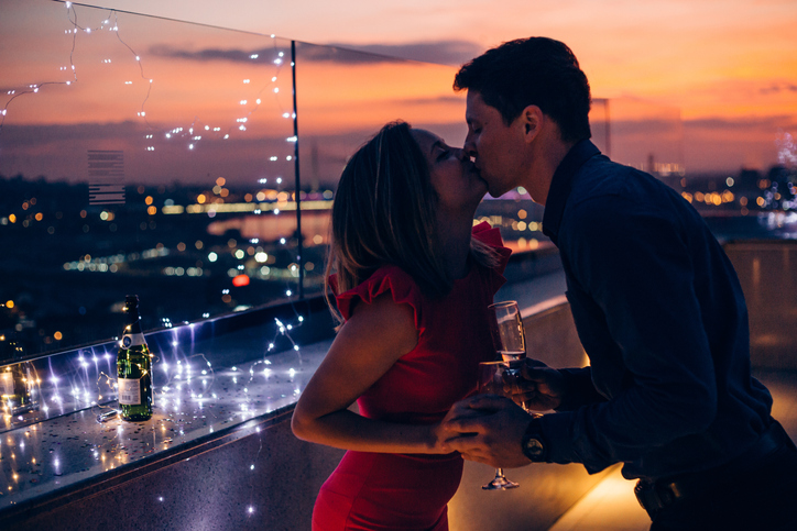 couple-on-building-celebrating-christmas